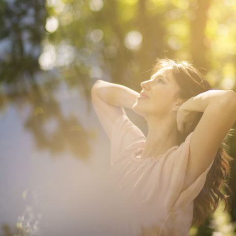 Healthy woman soaking up sunlight for natural vitamin D, with supplements for added support